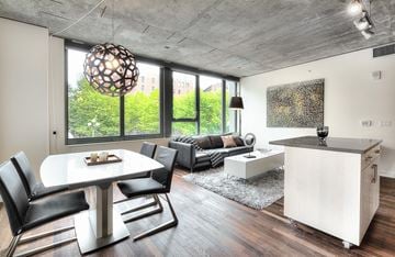 Seattle apartment for rent - a living room with a large window and a table and chairs