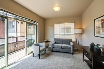 Seattle apartment for rent - a living room with a couch and a chair and sliding glass doors