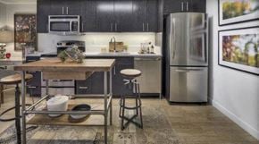 Seattle apartment for rent - A kitchen with a wooden table and a refrigerator.