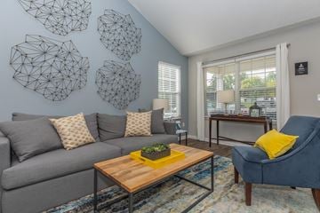 Streetsboro apartment for rent - a living room with a gray couch and a blue chair and a coffee table