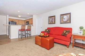Cuyahoga Falls apartment for rent - A living room with a red couch and a wooden coffee table.