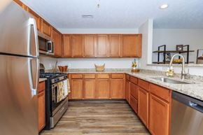 Kent apartment for rent - A kitchen with wooden cabinets and a stainless steel refrigerator.