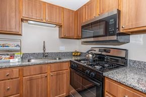 Brook Park apartment for rent - a kitchen with a stove microwave and sink