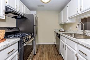 Medina apartment for rent - a kitchen with stainless steel appliances and white cabinets