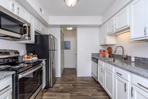 Westlake apartment for rent - A kitchen with black appliances and white cabinets.