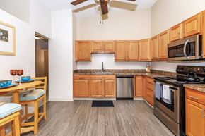 Aurora apartment for rent - A kitchen with wooden cabinets and a stainless steel oven.