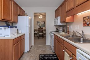 Roanoke apartment for rent - a kitchen with wooden cabinets and a sink and a refrigerator