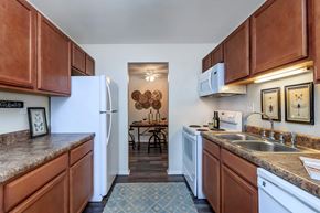 Lynchburg apartment for rent - a kitchen with white appliances and wooden cabinets