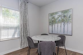 Aurora apartment for rent - a dining room with a table and chairs and a window
