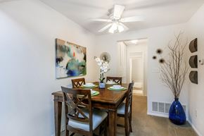 Roanoke apartment for rent - a dining room with a table and chairs and a ceiling fan