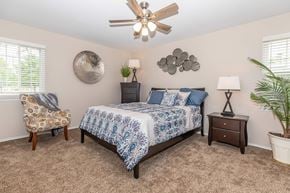 Brook Park apartment for rent - a bedroom with a bed and a ceiling fan