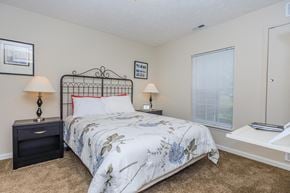 Cuyahoga Falls apartment for rent - A bedroom with a bed, nightstands, and a window.