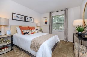Westlake apartment for rent - A bedroom with a large bed and a window with curtains.
