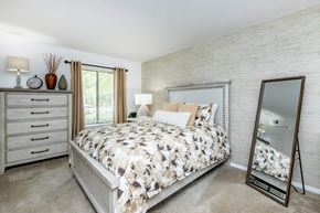 Blacksburg apartment for rent - a bedroom with a bed and a mirror