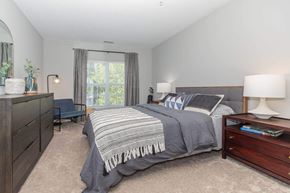 Watchung apartment for rent - a bedroom with a bed and a dresser
