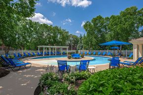 Oak Park apartment for rent - a resort style pool with blue chairs and umbrellas