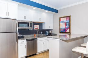 Sheffield Lake apartment for rent - A kitchen with white cabinets and a blue stripe on the wall.
