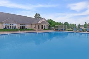 Clinton Township apartment for rent - a large pool with a house in the background