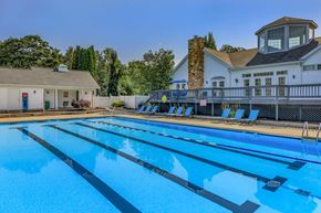 Aurora apartment for rent - A large swimming pool with lane dividers and a building in the background.