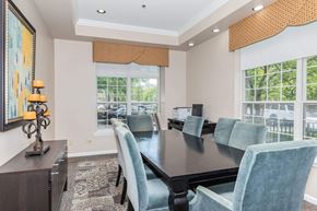 Beachwood apartment for rent - A dining room with a dark table and blue chairs.
