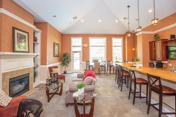 Avon apartment for rent - a living room with a fireplace and a table with chairs