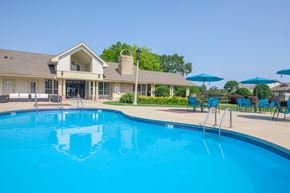 Greenfield apartment for rent - a swimming pool with a house in the background
