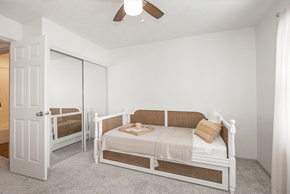 Medina townhouse for rent - A white bedroom with a bed and a dresser.