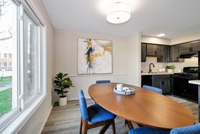 Harper Woods apartment for rent - A dining room with a wooden table and blue chairs.