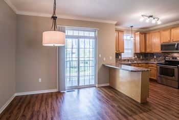 A kitchen with wooden floors and a large island