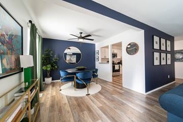 Southfield apartment for rent - A living room with a blue couch and a ceiling fan.