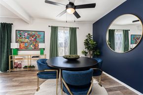 Southfield apartment for rent - A dining room with a round table and blue chairs.