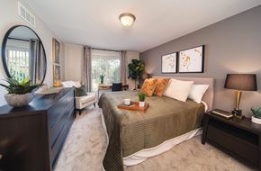 Troy apartment for rent - A bedroom with a large bed and a dresser.