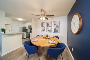 Greenfield apartment for rent - a dining room table with chairs and a clock on the wall