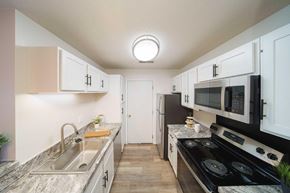 Greenfield apartment for rent - a kitchen with stainless steel appliances and white cabinets