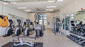 Mchenry apartment for rent - A gym with a variety of equipment including treadmills, weights, and exercise machines.