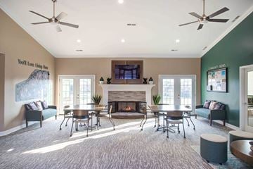 Rochester Hills apartment for rent - A living room with a fireplace and a tv on the wall.