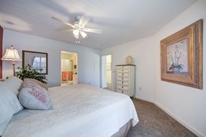 Mount Joy townhouse for rent - A bedroom with a bed, dresser, and a ceiling fan at The Crest at Elm Tree, Mount Joy, 17552
