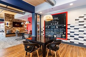 Blacksburg apartment for rent - a dining room with a table and chairs and a chalkboard on the wall