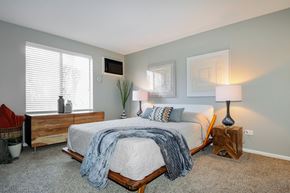 Naperville apartment for rent - A bedroom with a bed, nightstands, and a window.