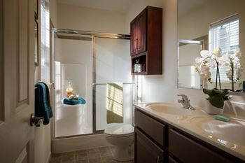 A bathroom with a toilet, sink, and shower