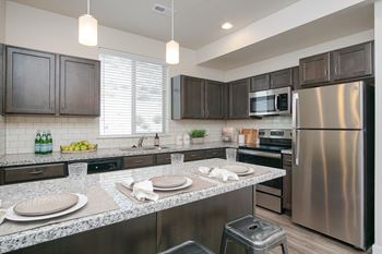 Contemporary kitchen with island seating and granite surfaces