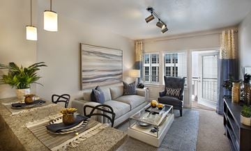 Salt Lake City townhouse for rent - A modern living room with a grey sofa, a coffee table, and a painting on the wall.