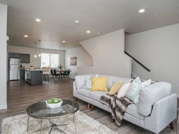 Draper apartment for rent - A modern living room with a grey couch and a glass coffee table.