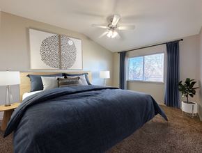 Draper townhouse for rent - Liberty Hill Apartments, Draper, Utah, bedroom with a large bed and a ceiling fan.