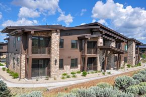 Park City apartment for rent - A modern house with a brown exterior and stone pillars.