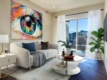 Salt Lake City apartment for rent - A living room with a large eye painting on the wall.