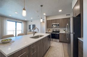 Park City apartment for rent - Liberty Sage Apartments, Park City, Utah, a modern kitchen with a large island and stainless steel appliances.