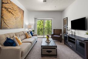 Salt Lake City apartment for rent - A living room with a brown couch and a painting on the wall.