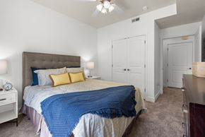 Salt Lake City apartment for rent - Bedroom with tufted headboard and closet doors at Liberty Gateway Apartments, Salt Lake City