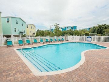Marathon apartment for rent - A small pool with a brick border and a white fence.